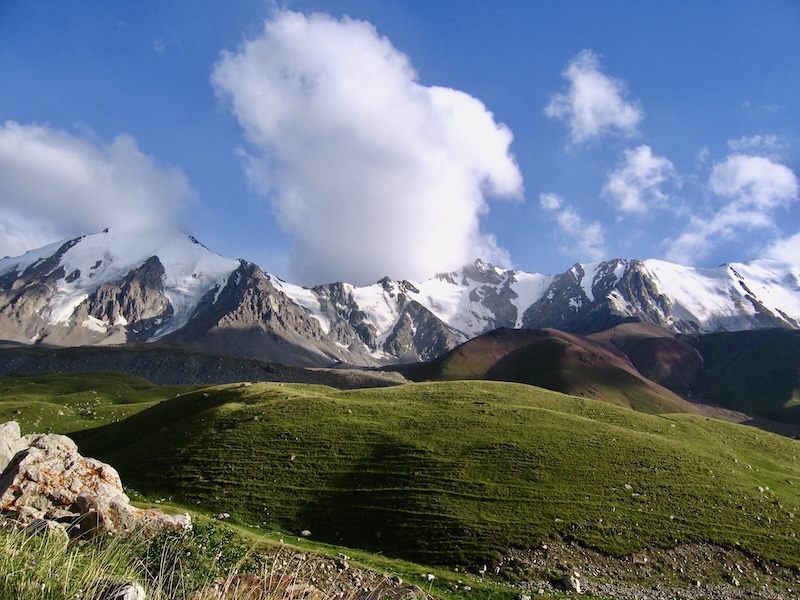 Alpine meadows and snow-covered mountain peaks in the upper Big Almaty Gorge, Northern Tien Shan