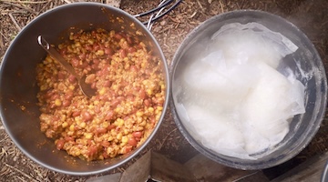 Preparing a hot meal at camp